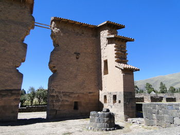Low angle view of old ruin against clear blue sky