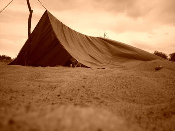 Sand dune in desert against sky