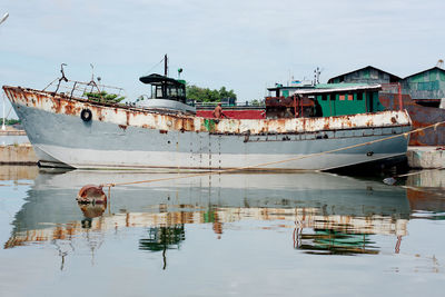 Old fishing boat in cinefuego. small port. rusty, distressed. calm day.