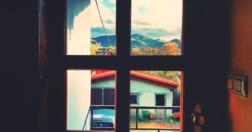 Buildings seen through window of house