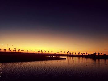 View of city at waterfront during sunset