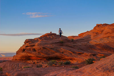 Woman walking on rock formation