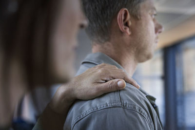 Mature woman touching man's arm