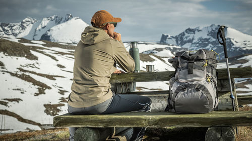 Rear view of man looking at lake