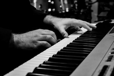 Midsection of man playing piano