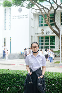 Portrait of young man standing on street