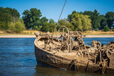 Scenic view of a wreck in the river against sky