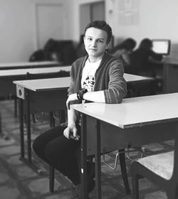 Portrait of young woman sitting on chair