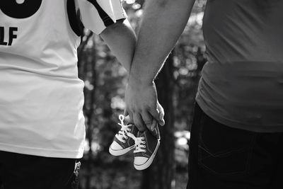 Midsection of couple holding hands