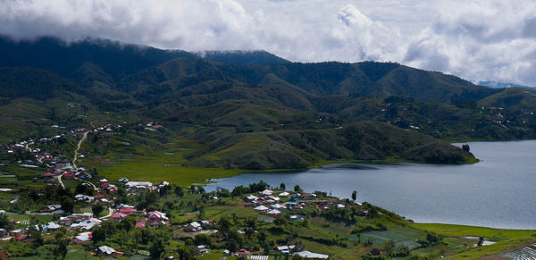 Scenic view of lake and mountains against sky