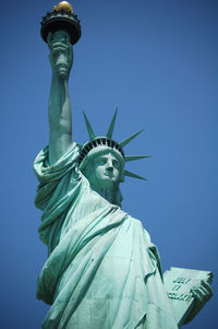 Low angle view of statue against blue sky