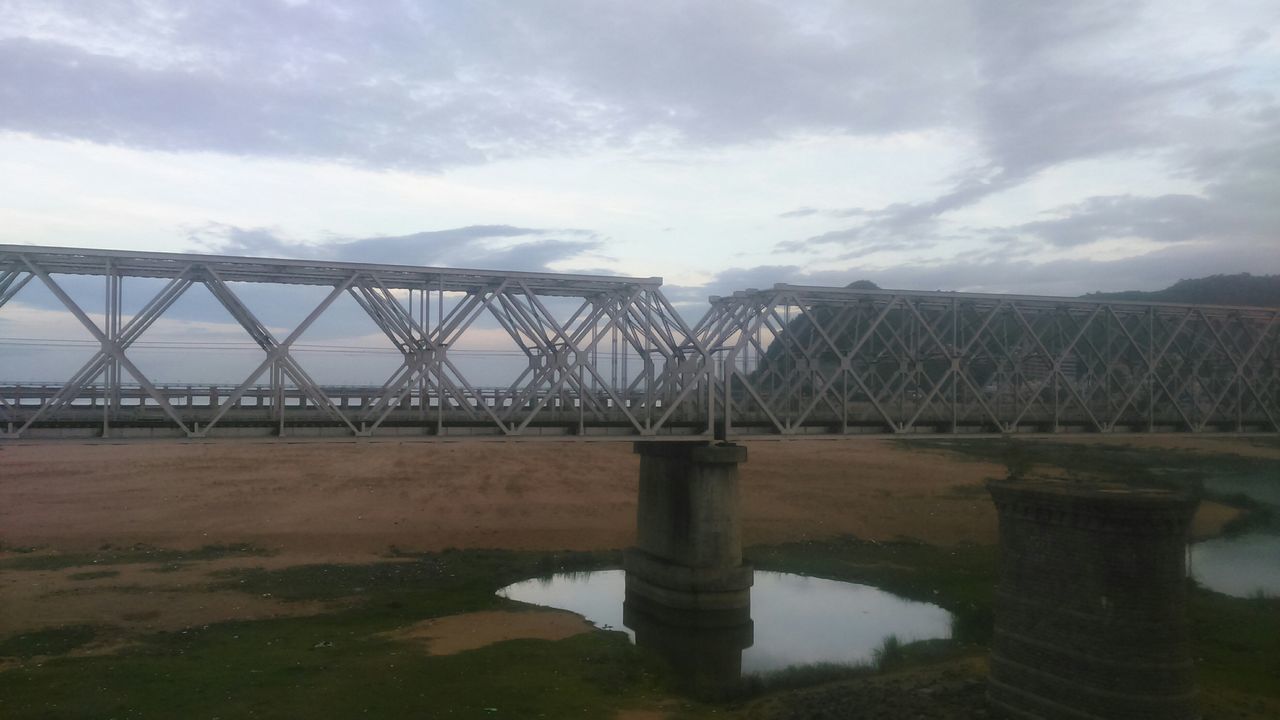 sky, built structure, connection, architecture, water, bridge - man made structure, cloud - sky, river, engineering, cloud, cloudy, nature, tranquility, no people, metal, outdoors, bridge, tranquil scene, day, reflection