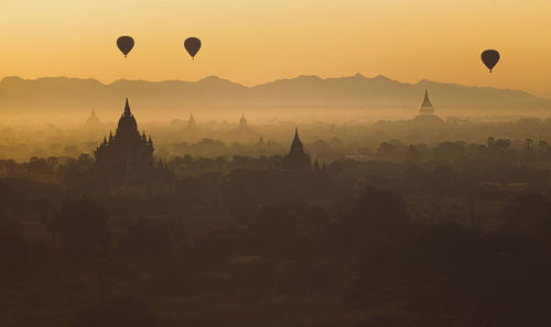 Hot air balloons against sky during sunset