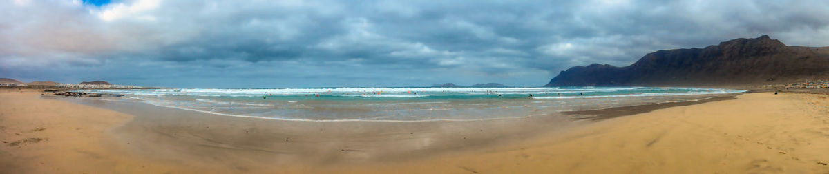 Panoramic view of beach against cloudy sky