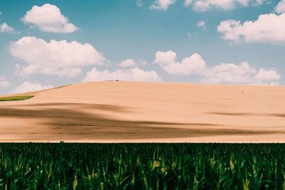 View of fields against cloudy sky