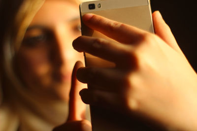 Close-up portrait of woman using smart phone