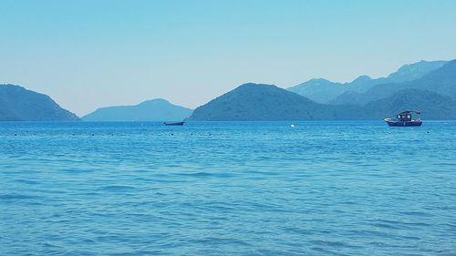 Sailboat in sea against clear sky