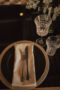 High angle view of plate and eating utensil on table in restaurant