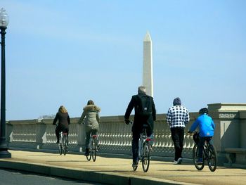 Rear view of people on bicycle