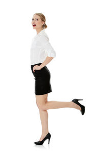 Full length of woman standing against white background