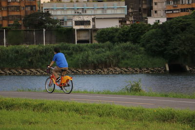 Man riding bicycle on grassland