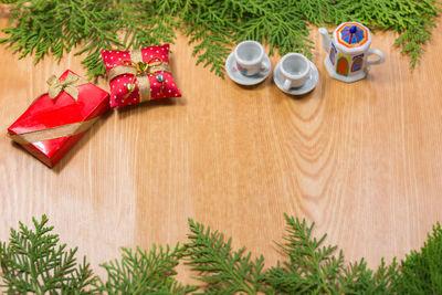 Close-up of pine tree with christmas decorations on wooden table