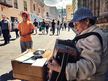 People playing guitar in city