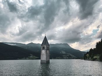 Historic building by mountain against sky