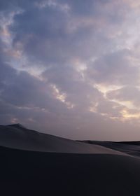 Low angle view of silhouette landscape against sky