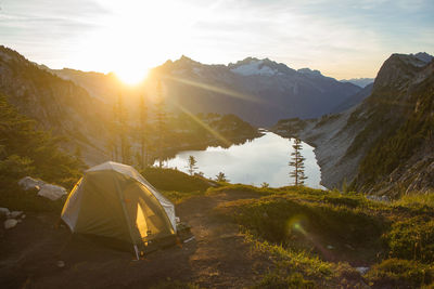 High angle view of tent by lake amidst rocky mountains