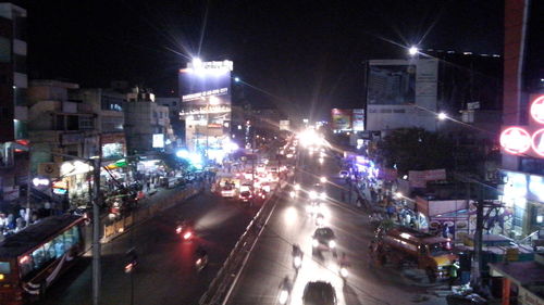 High angle view of city lit up at night