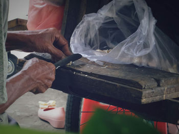 Cropped hand chopping vegetables