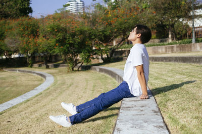 Side view of boy looking at farm