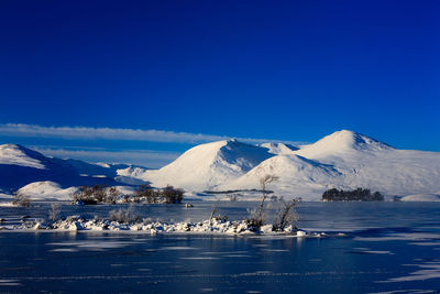 Scenic view of frozen lake against mountain range