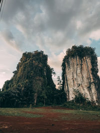 Rock formations on field against sky