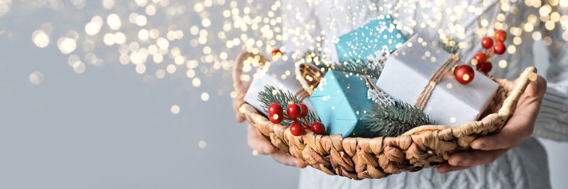 Midsection of person holding christmas decoration