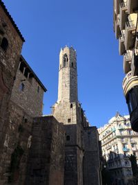 Low angle view of historic building against clear blue sky