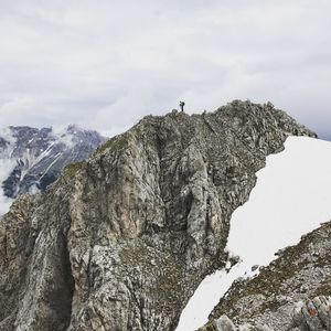 Low angle view of snow on mountain against sky