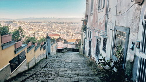 High angle view of footpath amidst buildings against cityscape