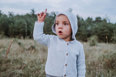 Portrait of cute girl standing on field