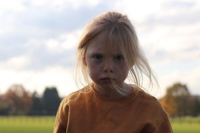 Portrait of girl against sky