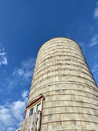 Low angle view of modern building against blue sky