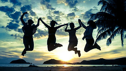 People on beach at sunset