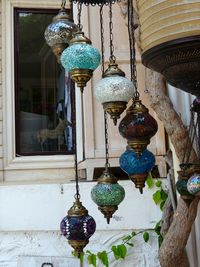 Close-up of lantern hanging against wall