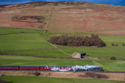 Side view of steam engine train on landscape