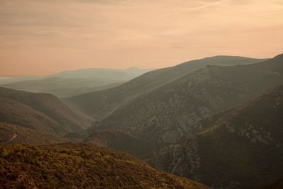 Scenic view of mountains against cloudy sky