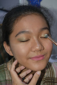 Close-up portrait of a beautiful young woman with eyes closed