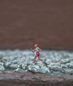 Side view of woman climbing on rock