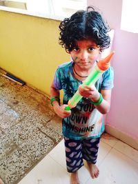 Portrait of cute girl standing at home