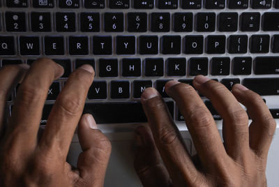 Midsection of mother using laptop